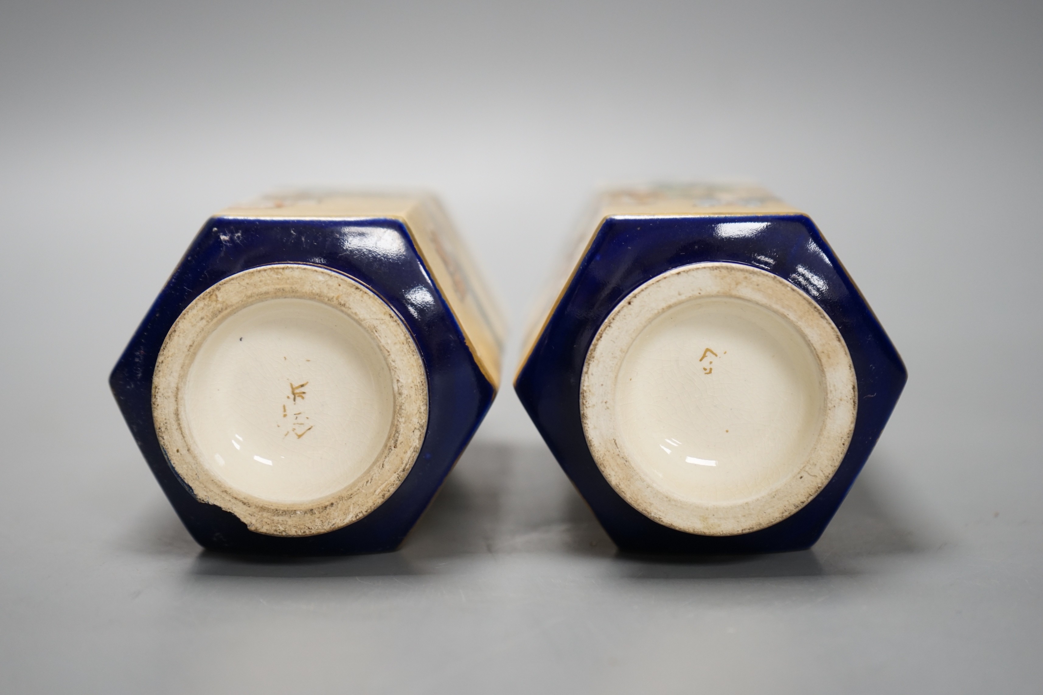 A pair of Japanese Satsuma pottery hexagonal vases, Meiji period, on stands 16cm